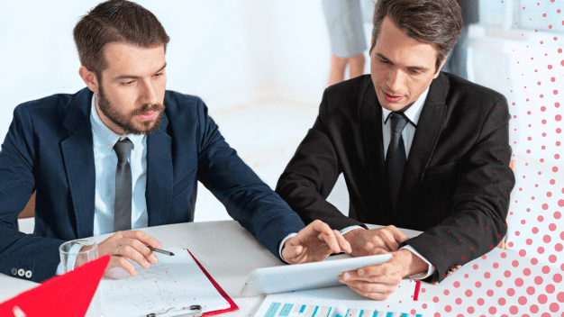 Business consultants collaborating on SAP SuccessFactors implementation strategy using a digital tablet during an HRIS consulting session